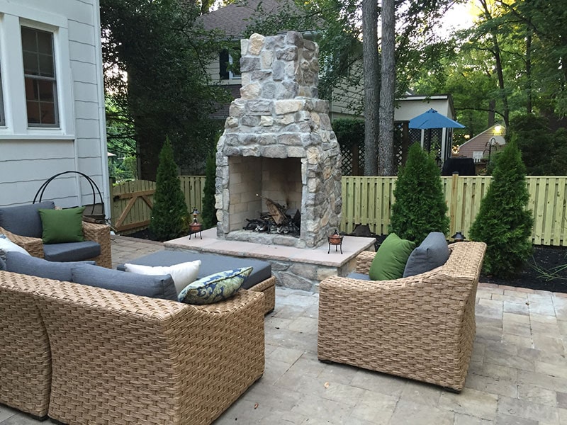 Glenwood Home Backyard Patio with Fireplace and Assorted Furniture